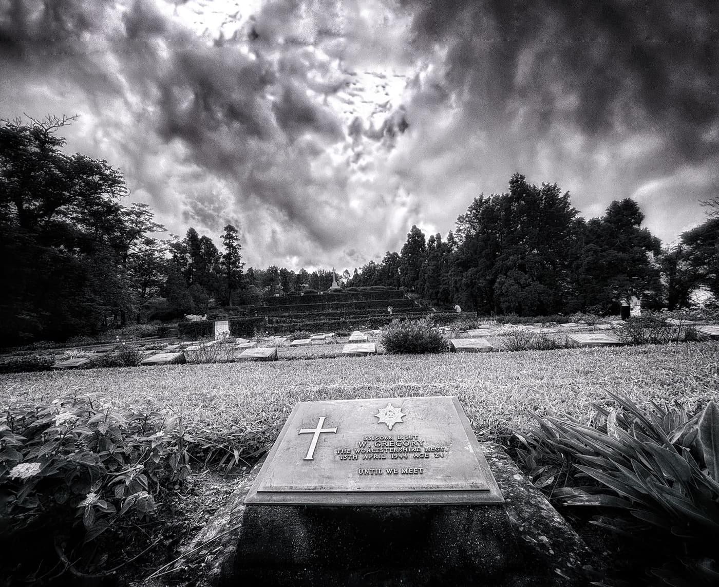 Kohima War Cemetery. Row after row of white headstones on a hillside.