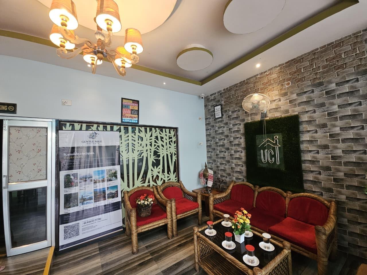 The seating area inside the Gentle Mile Holidays office, with cane sofas and a brick wall